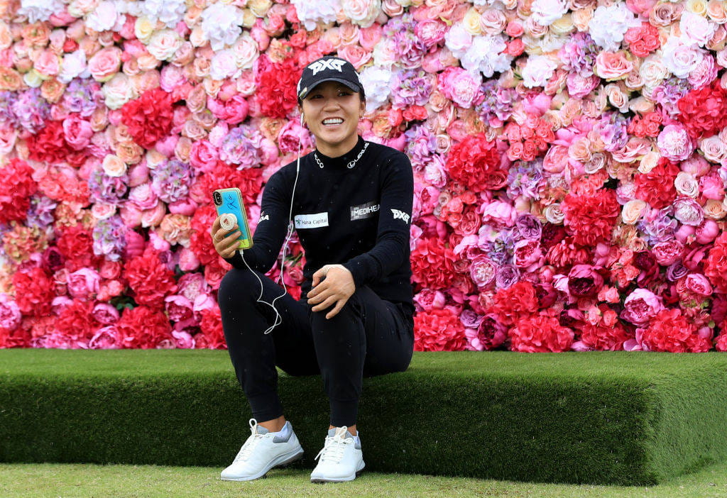 Lydia Ko poses with her cell phone at the AIG Women's Open